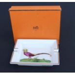 A Hermes of Paris large ceramic ashtray decorated with a golden pheasant and gilded rim, 20cms wide,