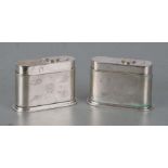 A pair of silver plated silver table lighters with engraved shell decoration, 6cms high (2).