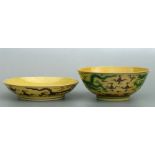 A Chinese footed bowl decorated with dragons chasing a flaming pearl amongst clouds on a yellow