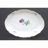 A Dresden oval dish decorated with flowers, 25cms wide.