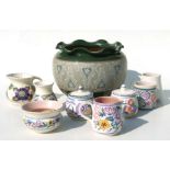 A quantity of Poole pottery items to include mugs, milk jug, sugar basins and other items;