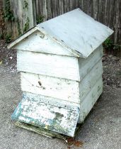 A decorative painted wooden four-section beehive, 85cms wide.