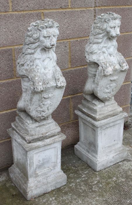 A pair of reconstituted stone rampant lions on square plinths, overall 115cms high. - Image 3 of 3