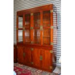 A Chinese hardwood display cabinet with two pairs of glazed doors enclosing a shelved interior