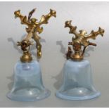 A pair of Art Nouveau WAS Benson style Pullman lamps with pale blue glass shades, one with