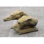 A reconstituted stone garden statue in the form of a pair of greyhound heads, approx 46cms long.