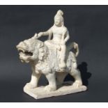 A large Chinese white marble carving depicting Guanyin riding a Qilin, 48cms high.