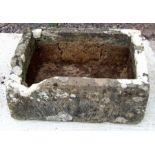 A large well weathered carved stone trough, 76 by 54cms.