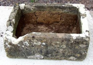 A large well weathered carved stone trough, 76 by 54cms.