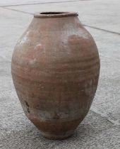 A terracotta olive jar of tapering traditional form with sgraffito decoration, approx 64cms high.