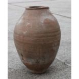 A terracotta olive jar of tapering traditional form with sgraffito decoration, approx 64cms high.