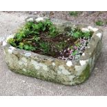 A well weathered carved stone trough, 64 by 48cms.