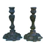 A pair of French bronze rococo style candlesticks, 27cms high (2).