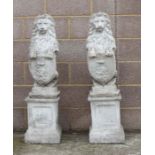 A pair of reconstituted stone rampant lions on square plinths, overall 115cms high.