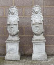 A pair of reconstituted stone rampant lions on square plinths, overall 115cms high.