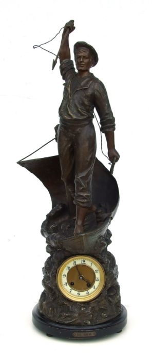 A late 19th / early 20th century bronzed and patinated figural mantle clock in the form of a