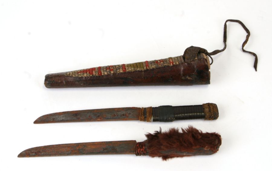 A pair native American daggers in a leather scabbard with needlework decoration, one with a fur