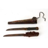 A pair native American daggers in a leather scabbard with needlework decoration, one with a fur