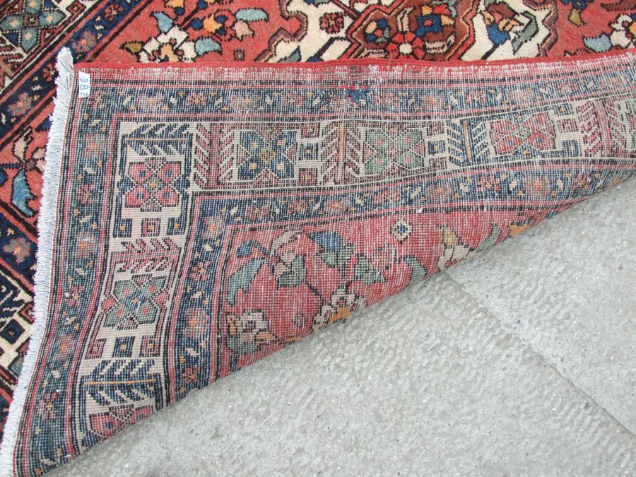 A Persian Azari woollen hand knotted Azari runner with three central guls within geometric floral - Image 3 of 4