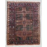 A Persian rug with geometric design on a brown ground, 110 by 180cm