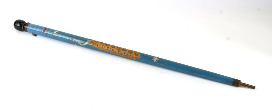 A vintage novelty walking stick / snooker cue decorated with a peacock, 86cms long.