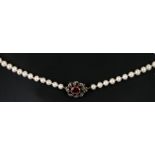 An antique graduated pearl necklace with yellow metal diamond and ruby set clasp.