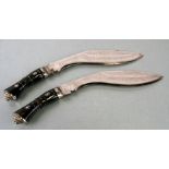 A pair of kukri knives with engraved blades, each 38cms long (2).