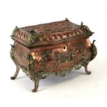 A 19th century continental copper and brass bombe jewellery casket decorated in relief with cherubs,