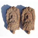 A pair of large terracotta wall pockets in the form of a bearded man, 44cms high (2).