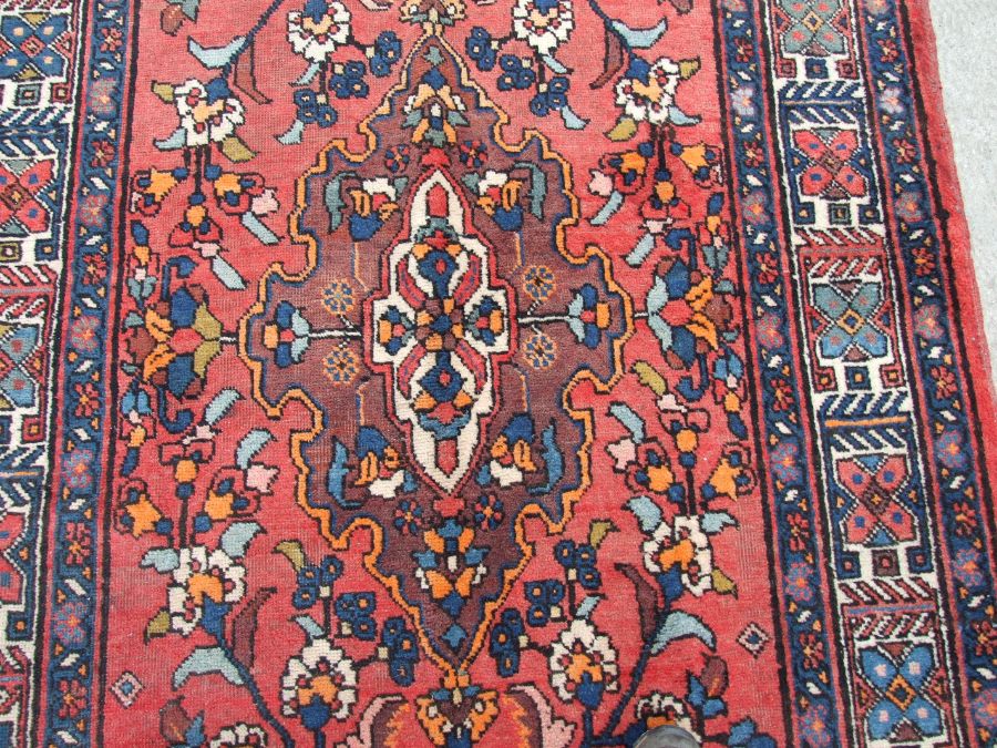 A Persian Azari woollen hand knotted Azari runner with three central guls within geometric floral - Image 2 of 4
