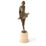 An Art Deco cold painted spelter figure of a female dancer on an onyx plinth, 32cms high.