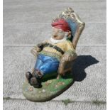 A painted reconstituted stone figure of a seated gnome, 43cms high.