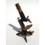 A late Victorian brass and black lacquered monocular microscope, 30cms long.