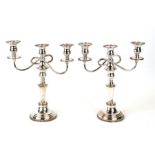 A pair of three-branch silver plated candelabra, 33cms high (2).Condition ReportSome wear to