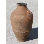 A terracotta olive jar of cylindrical tapering form, 67cm high