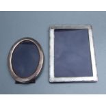 A silver photograph frame, London 2001, overall 16 by 21cms; together with an oval silver photograph