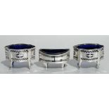 A pair of Edwardian pierced silver salts with blue glass liners, Birmingham 1910. 9cm wide