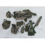 A quantity of assorted military uniform items to include ammunition belts and similar items.