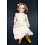 A German bisque head doll with sleeping eyes and composite limbs. 38cm high