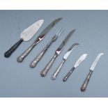 A quantity of silver handled serving cutlery to include carving fork and cake slice.