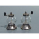 A pair of Victorian silver mounted glass pepper grinders, London 1886, and makers mark for John