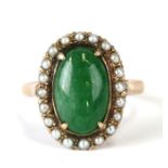 A 14ct gold jade and seed pearl cluster ring. Approx. UK size L. 3.8g