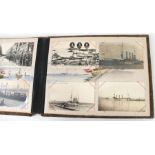 An early 20th century lacquered postcard album containing topographical postcards to include