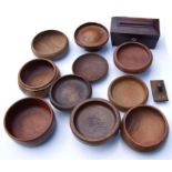 A collection of treen items including a footed bowl, 24cm diameter, another bow,l 23cm diameter,