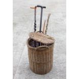 A swagger stick, a holly walking stick, other walking sticks in a wicker basket, (5)