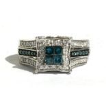 A 14ct white gold blue diamond and white diamond ring, approx UK size 'N'.Condition ReportMinor