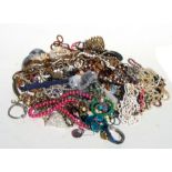 A large quantity of costume jewellery to include necklaces and bangles.