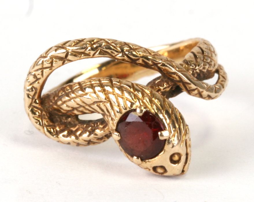A 14ct gold snake ring set with a single garnet. Approx. UK size I. 3.9gCondition Reportgood