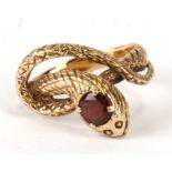 A 14ct gold snake ring set with a single garnet. Approx. UK size I. 3.9gCondition Reportgood
