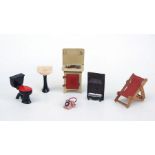 A quantity of doll's house furniture to include a cooker, cooking pots and tea sets etc.